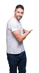 Young man wearing casual white t-shirt over isolated background Inviting to enter smiling natural with open hand