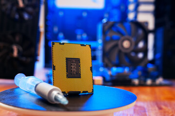 Computer processor with thermal paste close up. Modern computer part with PC case on background....