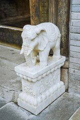vintage retro traditional style decorative element myth elephant animal figure statue in front of a...