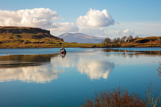 Old boat in calm water, Sound of Kerrera, Oban, Argyll and Bute, Scotland, UK.