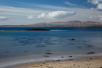 Sunny afternoon looking across Ganavan Bay with the Isle of Mull in the distance. Oban, Argyll and Bute, Scotland.