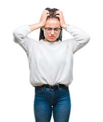 Fototapeta premium Young braided hair african american girl wearing glasses and sweater over isolated background suffering from headache desperate and stressed because pain and migraine. Hands on head.
