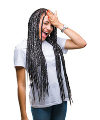 Young braided hair african american girl over isolated background surprised with hand on head for...