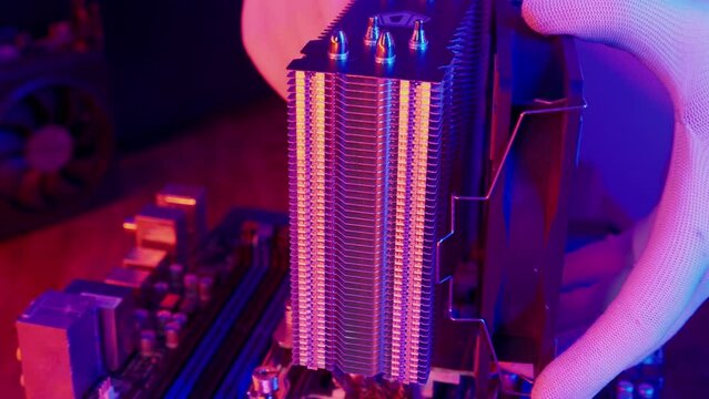 Air cooling system uninstalling on CPU Micro Processor in PC Motherboard close up. Technician cleans Hardware Computer components. Concept of desktop PC maintenance and service.