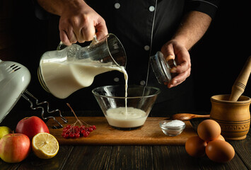 An experienced chef prepares a delicious dinner with eggs and milk. Diet menu concept for a...