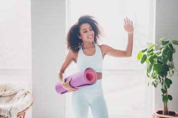 Photo of happy smiling lady activewear enjoying practicing sports vawing arm hi indoors room home house © deagreez