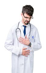 Fototapeta premium Young doctor man wearing hospital coat over isolated background with hand on stomach because nausea, painful disease feeling unwell. Ache concept.