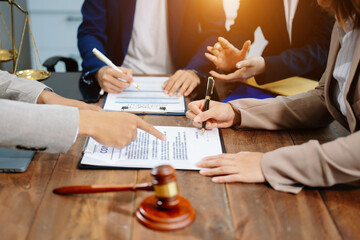 Business and lawyers discussing contract papers with brass scale on desk in office. Law, legal...