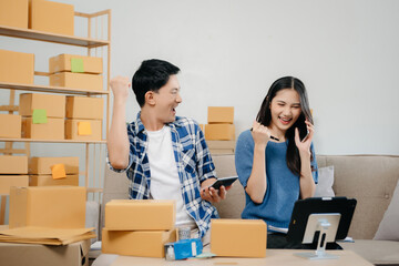 Small business entrepreneur SME freelance Asian man and woman working at home office, BOX, tablet...