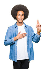 Young african american man with afro hair Swearing with hand on chest and fingers, making a loyalty promise oath