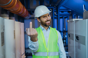 Middle age man wearing protective uniform showing middle finger doing fuck you bad expression,...