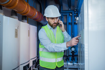 engineer checking and inspecting heating system of industrial air compressor system at air...