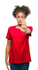 Young afro american woman over isolated background doing stop sing with palm of the hand. Warning expression with negative and serious gesture on the face.