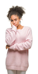 Young afro american woman wearing winter sweater over isolated background thinking looking tired...