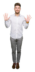 Naklejka premium Young handsome business man showing and pointing up with fingers number ten while smiling confident and happy.