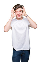Young handsome man wearing casual white t-shirt over isolated background Trying to open eyes with fingers, sleepy and tired for morning fatigue