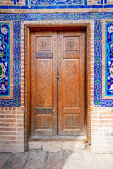 Carved wooden door in the Ulugh Beg Madrasah on the Registan Square in Samarkand, Uzbekistan
