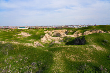 Fototapeta premium Afrasiyab (Afrosiyob) ancient settlement in ruins in Samarkand, Uzbekistan - Archaeological excavations on a grassy hill of Maracanda in Central Asia