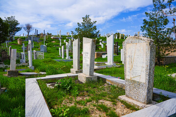 Graves in the grass at the Shah-i Zinda Elite Cemetery in Samarkand, Uzbekistan