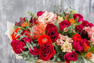 Small Beautiful bouquet of mixed flowers in woman hand. Floral shop concept . Beautiful fresh cut bouquet. Flowers delivery