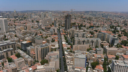 Fototapeta premium Jerusalem center city with red rooftops and tall buildings, drone view Drone view from center of Jerusalem at noon, israel, 2022 