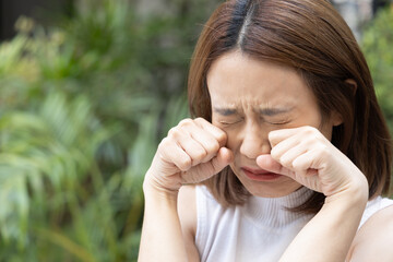 Young female’s tear, sad unhappy failed and frustrated young East Asian woman crying, weeping,...