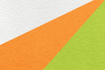 Fototapeta premium Texture of old craft white, orange and green color paper background, macro. Vintage abstract cardboard