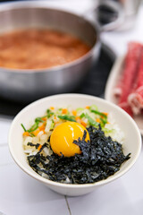 Bibim Rice Bowl: Traditional Korean Mixed Rice with Raw Egg Yolk, Seaweed, and Fresh Vegetables