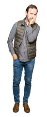 Middle age handsome man wearing winter vest thinking looking tired and bored with depression problems with crossed arms.