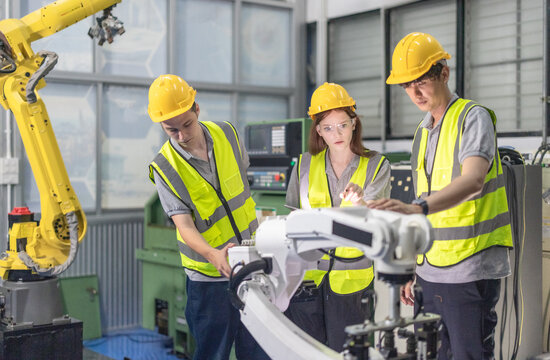 Trainees master robotics with hands-on workshops and quality control in manufacturing academy.