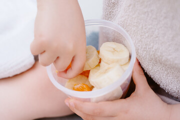 Little Child Eating a Healthy Fruit Snack Closeup with Shallow Depth of Field