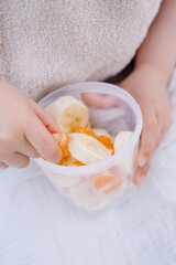 Little Child Eating a Healthy Fruit Snack Closeup with Shallow Depth of Field