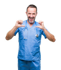 Middle age hoary senior doctor man wearing medical uniform over isolated background looking confident with smile on face, pointing oneself with fingers proud and happy.