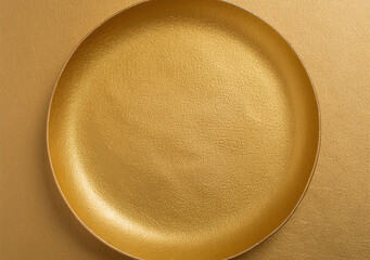Top view of golden plate on gold background