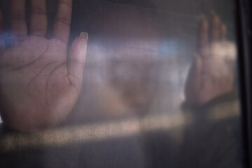 Hands, window and trapped in dark for depression, escape and person on train with mental health,...