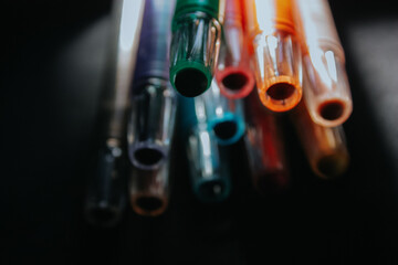 various colored crayon pencils on a black background