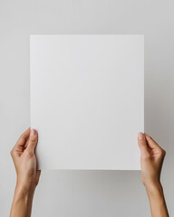 Hands holding blank paper mock up isolated on white background