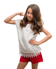 Brunette hispanic girl smiling doing phone gesture with hand and fingers like talking on the...