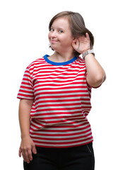 Young adult woman with down syndrome over isolated background smiling with hand over ear listening an hearing to rumor or gossip. Deafness concept.