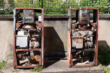 Two old-timey gas pump. Old rusty gas pump in a street. Old Gasoline Pump in France