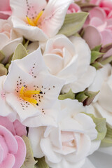 Zephyr bouquet of flowers in a wicker basket on a light background