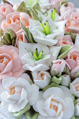 Zephyr bouquet of flowers in a wicker basket on a light background