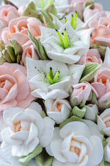 Zephyr bouquet of flowers in a wicker basket on a light background