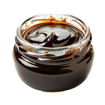 Organic and natural molasses in a glass jar.