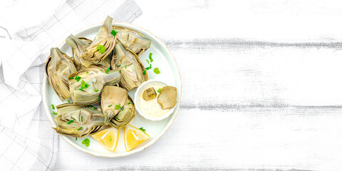 Traditional italian artichoke «alla romana», cooked carciofi vegetable. Olive oil, garlic, parsley