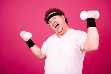 Sports nutrition and healthy lifestyle. Funny fat man and his bad habits. Pink background. 