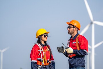 couple engineer team inspection check control wind power machine construction installation in wind energy factory. Two technician professional worker discussion for maintenance wind power turbine