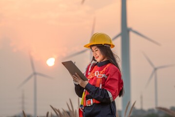 Woman engineer inspection posing check control wind power machine in wind energy factory at...