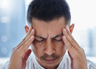 Fototapeta premium Businessman, frustrated and headache with stress in office burnout, overworked and mental health Male person, employee and anxiety with hand on temples for pressure, deadline and pain of migraine