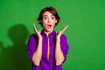 Portrait photo of upset young brown haired lady in violet shirt panic raised hands up dissatisfied...